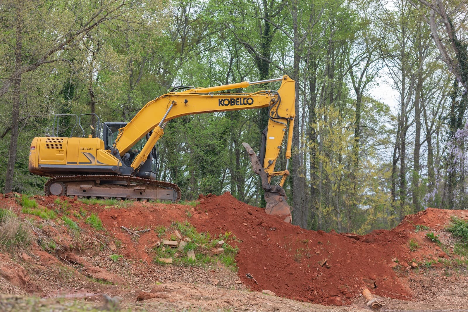 Red Dirt Contracting excavator working on red clay soil
